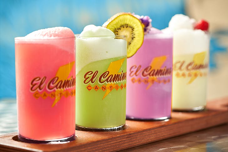 a row of four colourful margaritas